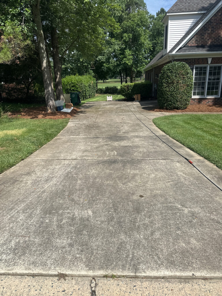 lancaster pro wash cleaning a concrete driveway removing dirt and stains with pressure washing techniques
